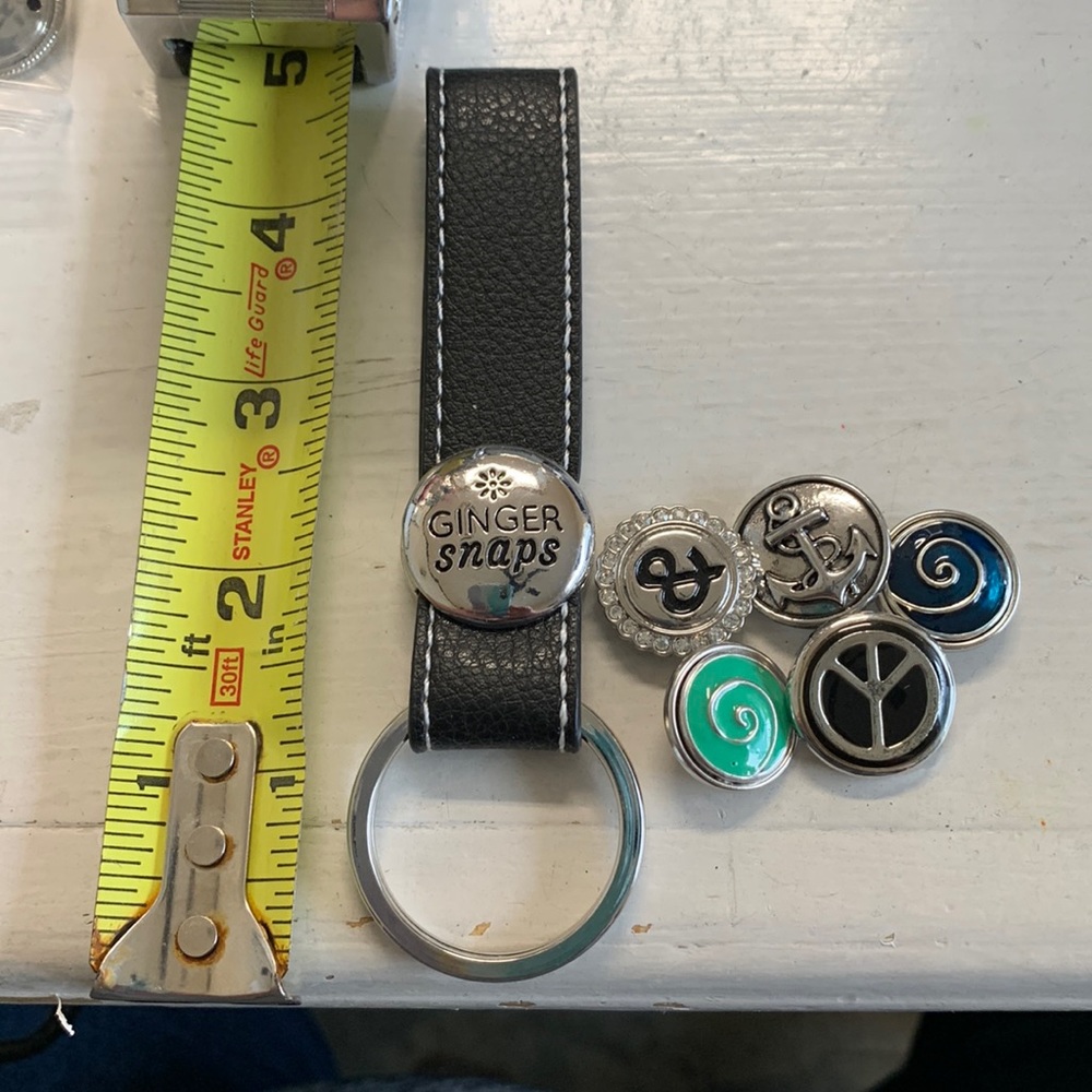One 4.5” black leather strap key rings for changeable snap and 5 snaps.. NWOT.